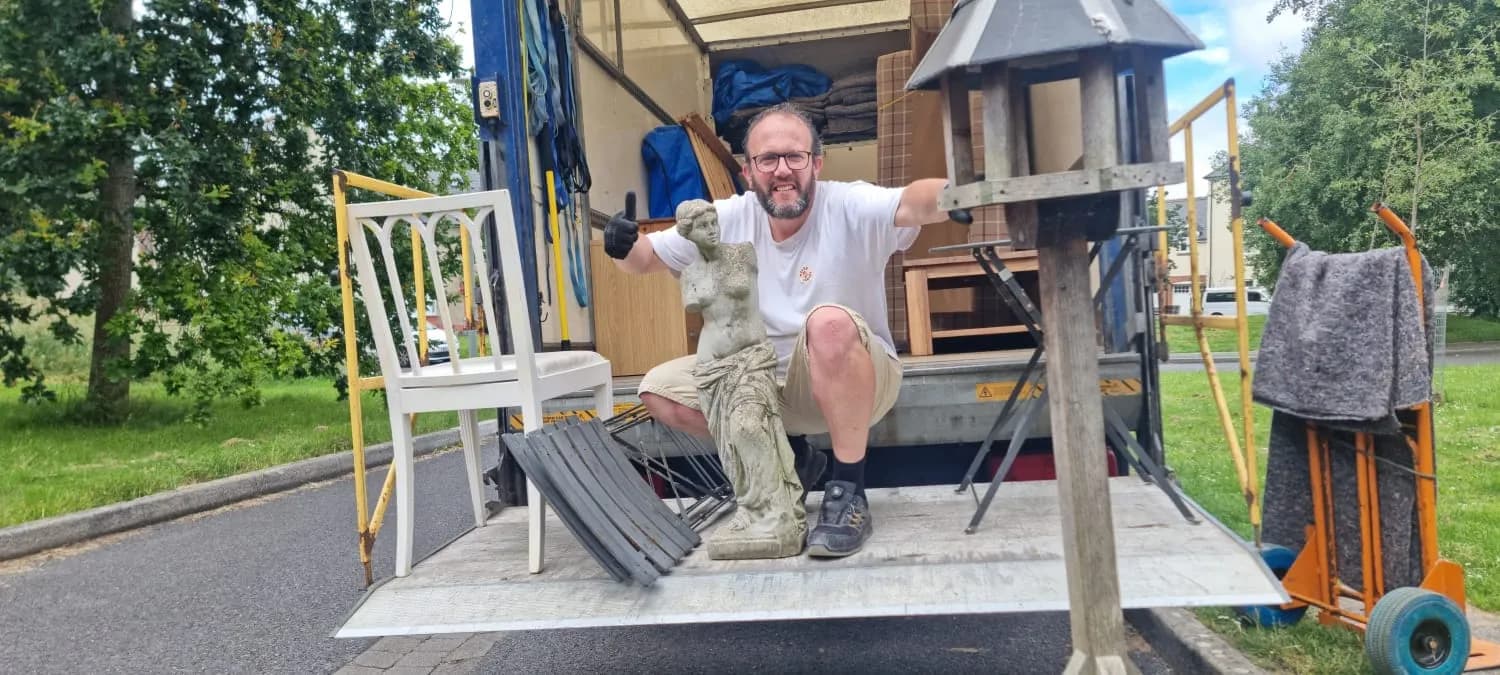 Loading a stone statue and garden furniture onto the tail-lift