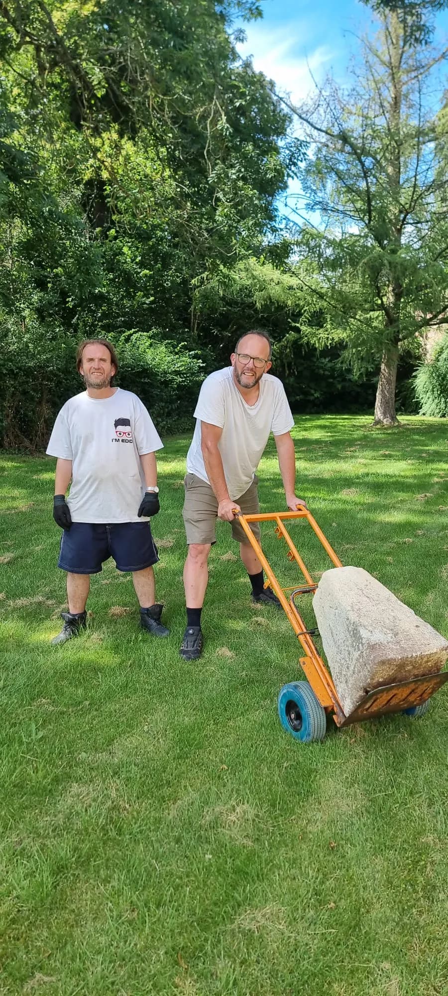 Wheeling a heavy stone block across a lawn on the sack truck